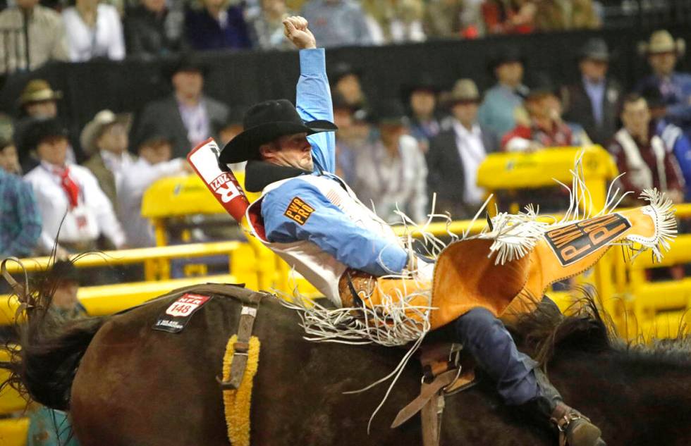 Kaycee Feild of Genola, Utah competes in the bareback riding event during the eighth go-round of the National Finals Rodeo.